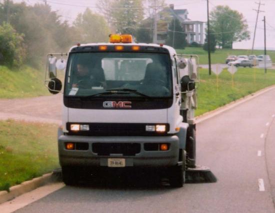 Street sweeper clearing debris off the road.