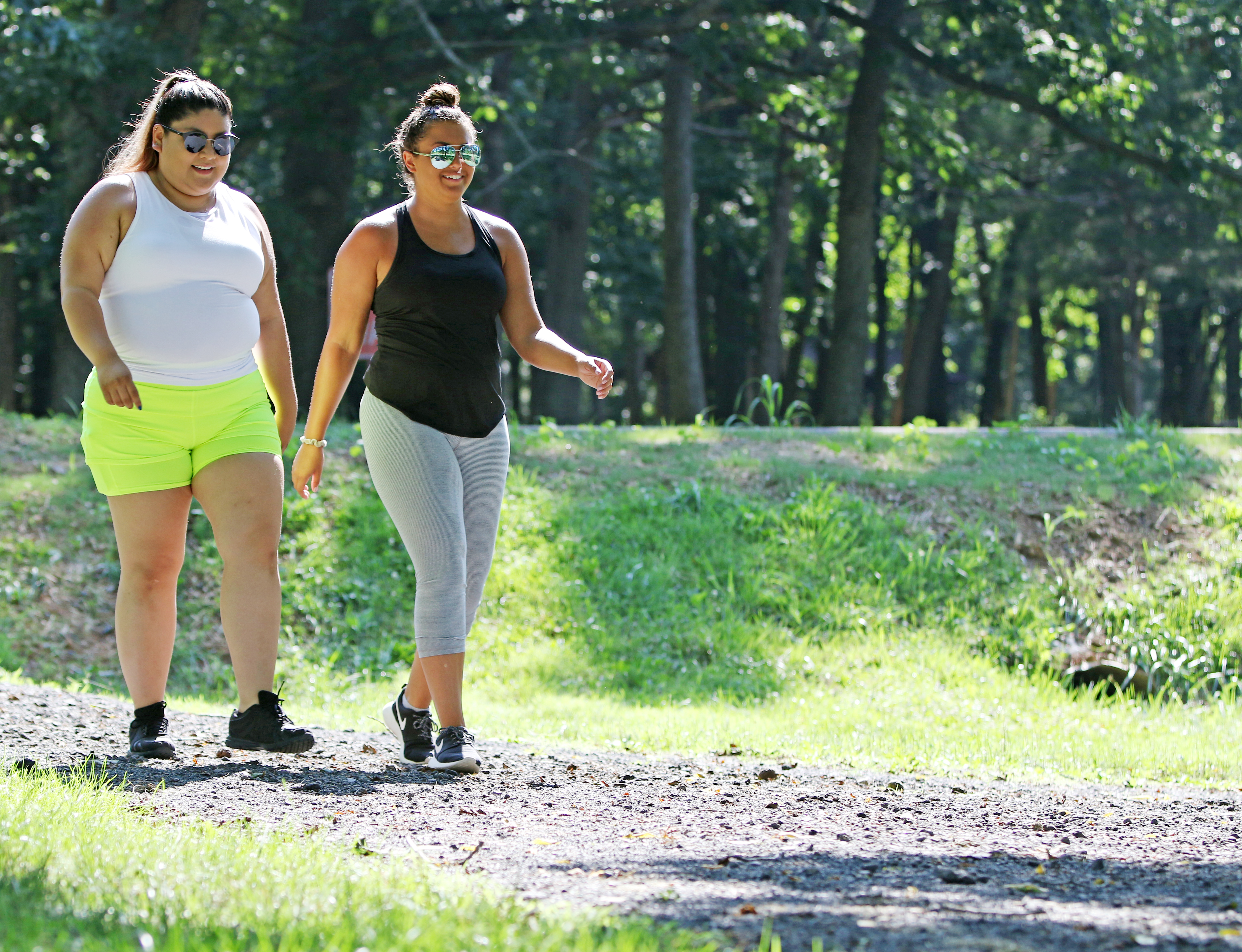 Two women walk a gravel path in Hillandale Park